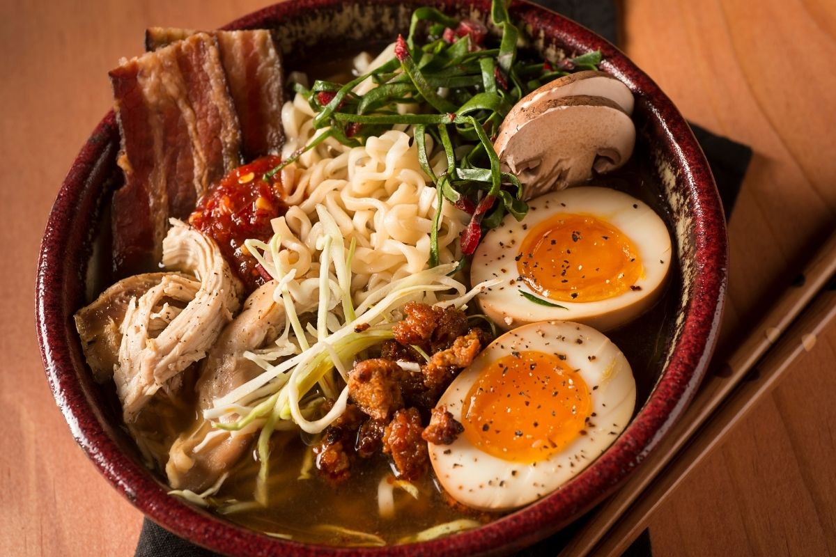 Big, beautiful bowl of ramen with eggs, mushrooms, and various proteins.
